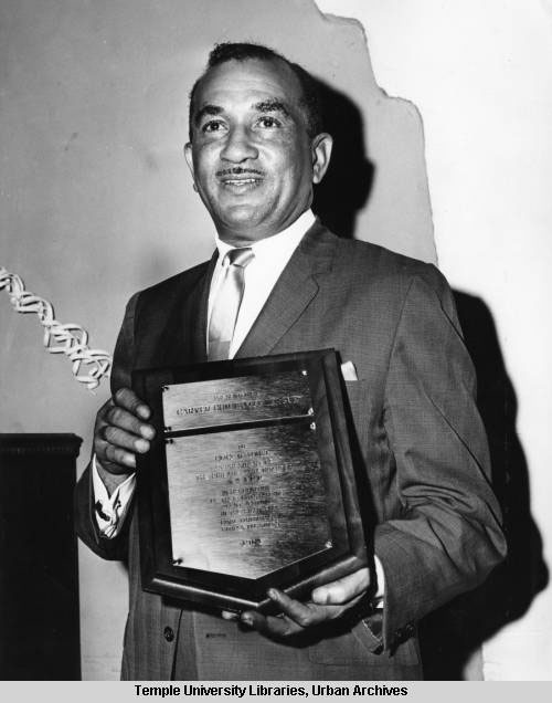 Cecil B. Moore holding an award