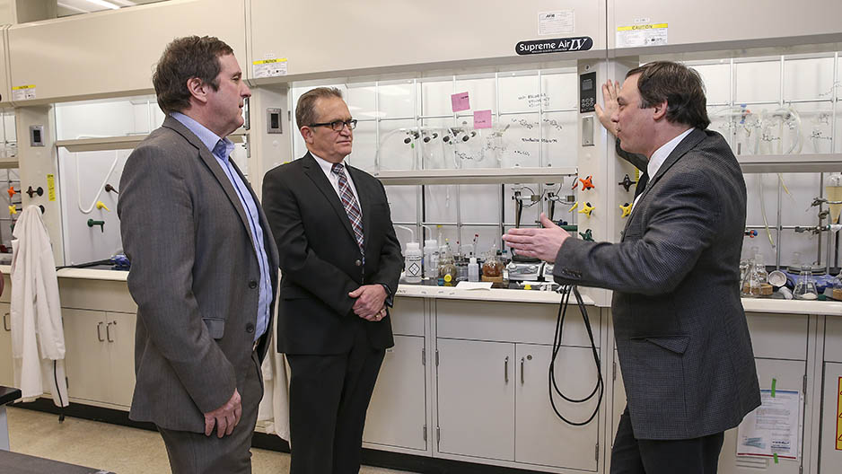 The CEO of Praeventix talks with Temple scientists in the lab.