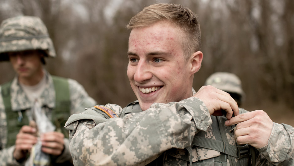 ROTC student in fatigues smiling during training