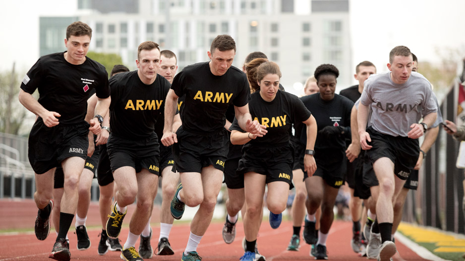 ROTC students in black "Army" T-shirts running together