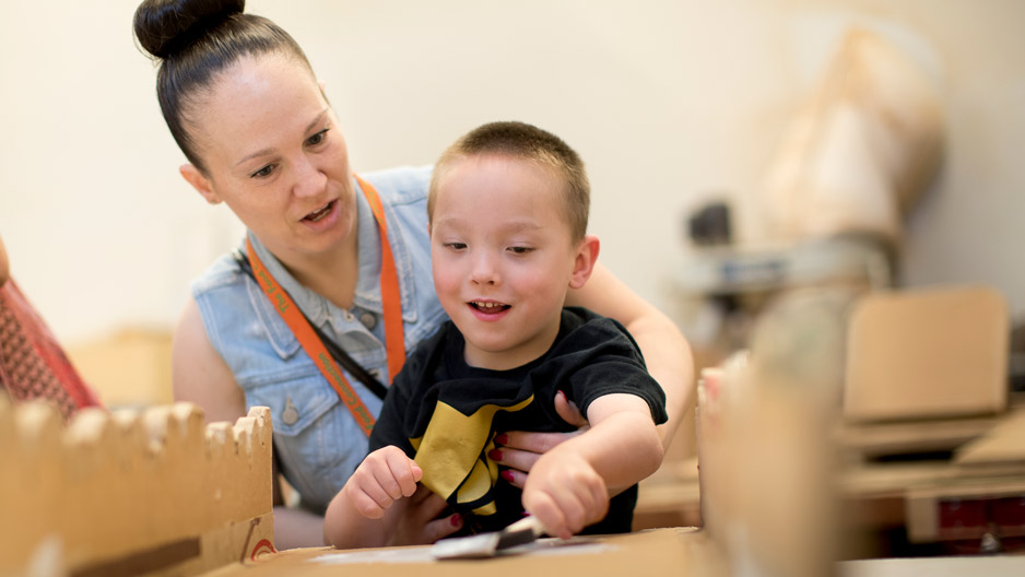 Mark Ovington, 5, painting a cardboard adaptation with help from mom