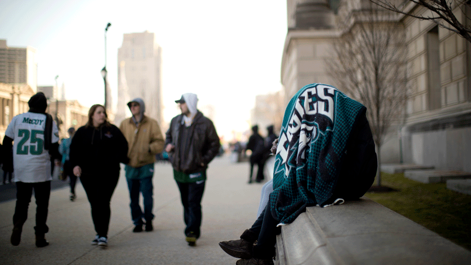 A fan covers up with an Eagles blanket