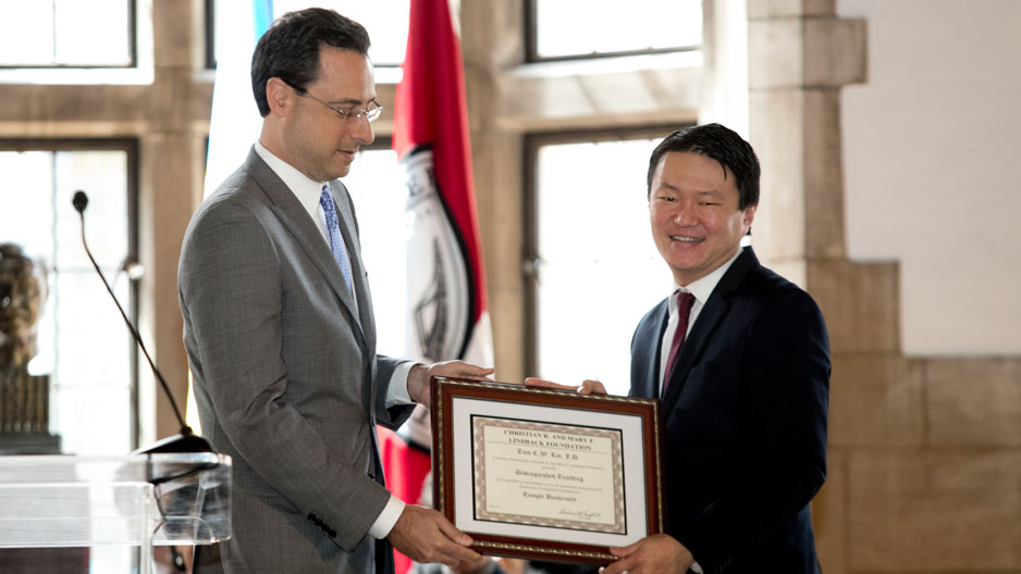 Dean Greg Mandel presents an award to Professor Tom Lin