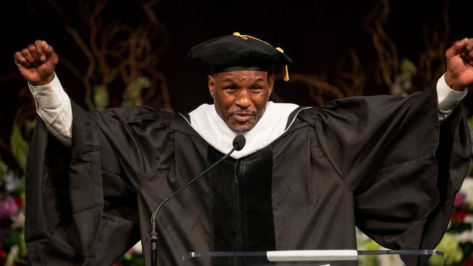 Bernard Hopkins raising his fists while giving a Commencement address