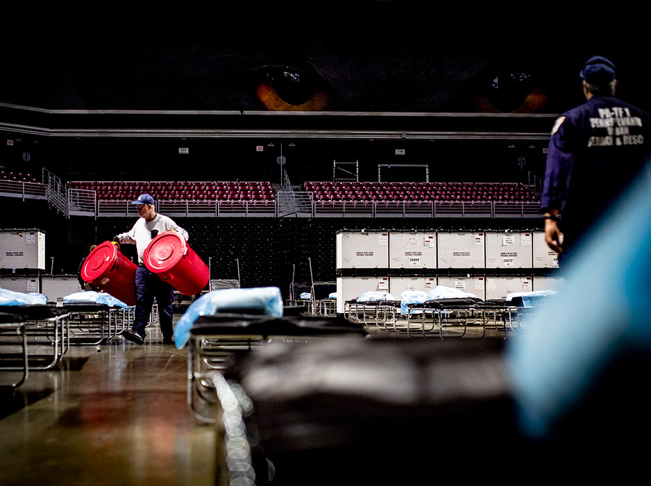 workers bring medical supplies into Liacouras Center