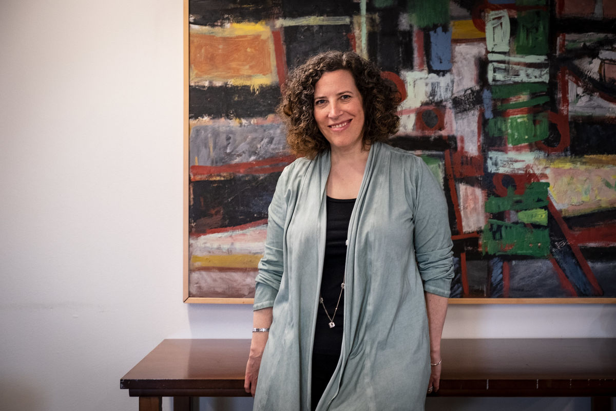 Photo of Judith Levine in front of a painting.