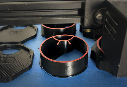 black plastic pieces on 3-D printer