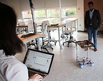 students in lab with autonomous robot