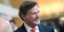 Larry Kaiser smiling as he mingles with guests at medical school event.