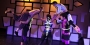 Dancers lifting each other up on stage with purple lighting.