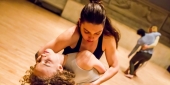 Two women dancers embracing.