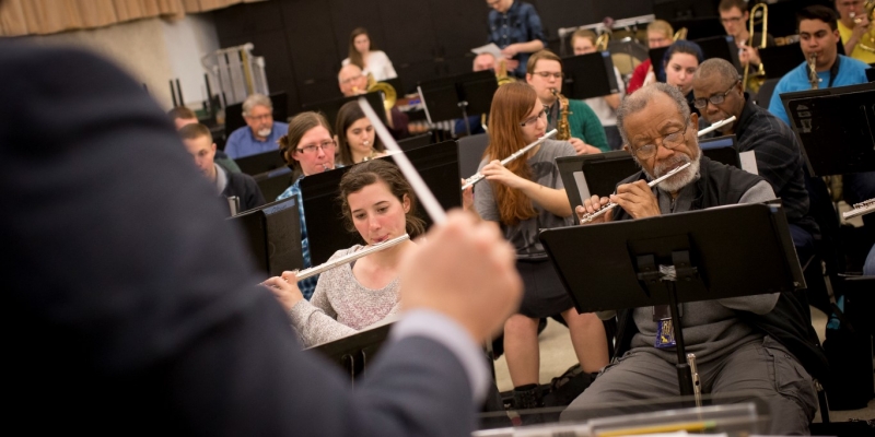 Several members of Temple's community band playing the flute.