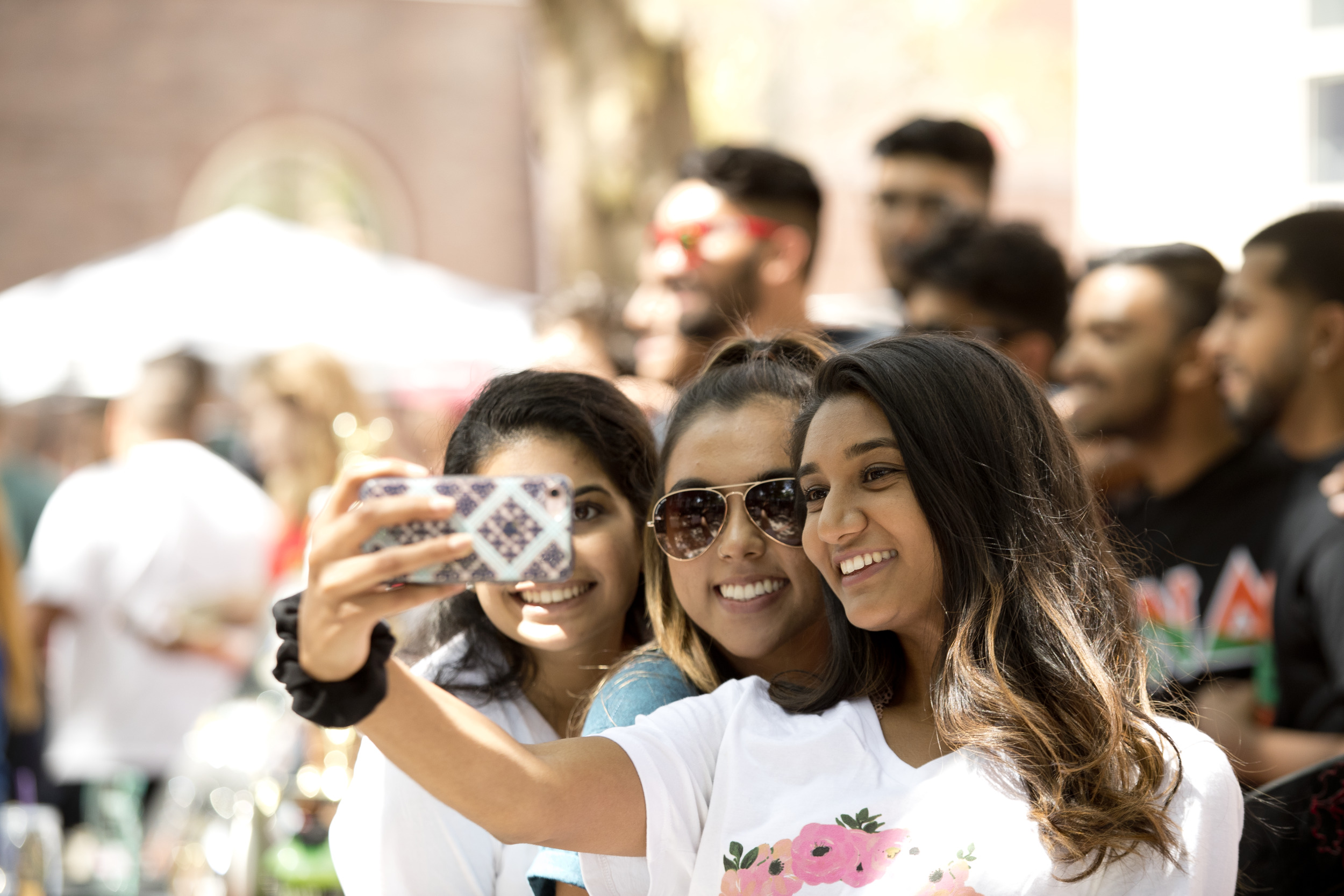Students taking a selfie together outside