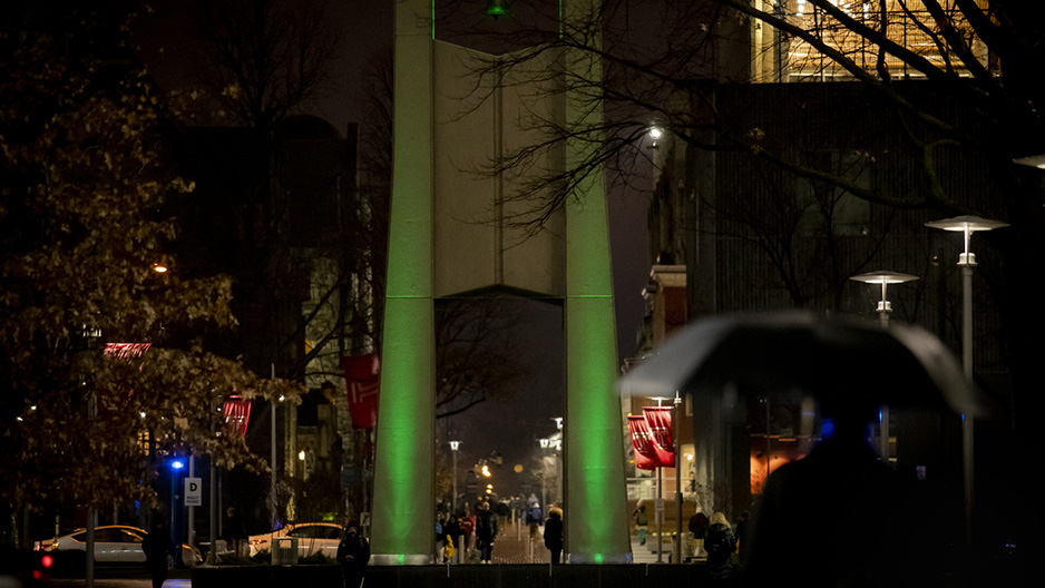 the bell tower on Main Campus, lit with green lights for Black History Month