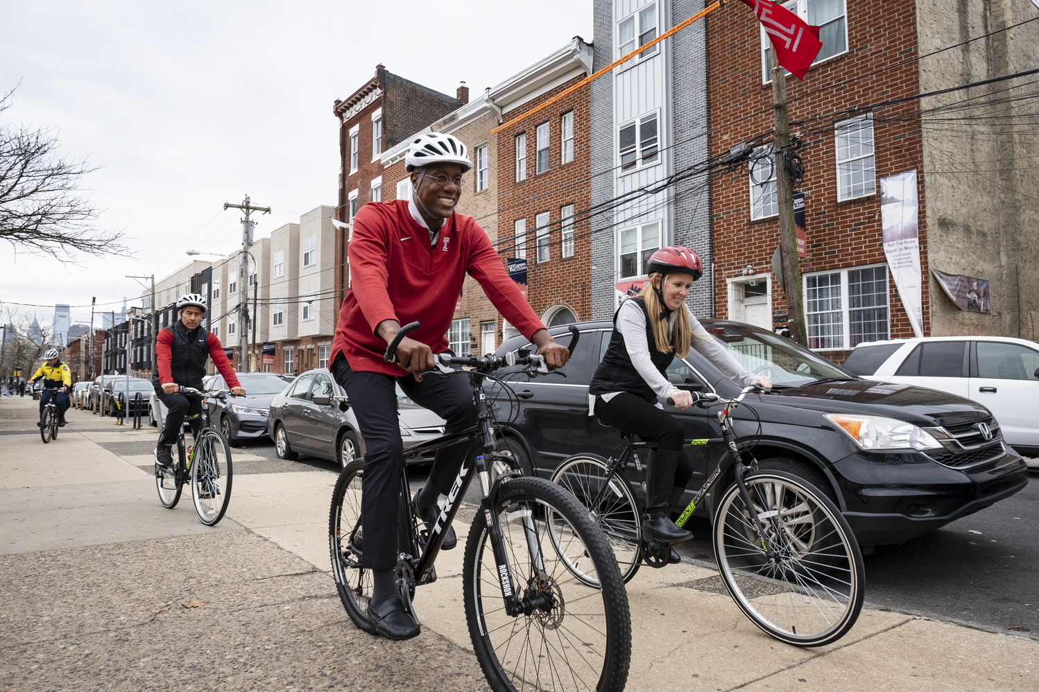 Image of Temple President Jason Wingard riding a bike.