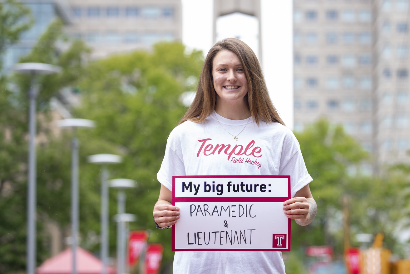 McKenna Burkhardt holding a sign that says "My Big Future: Paramedic and Lieutenant"
