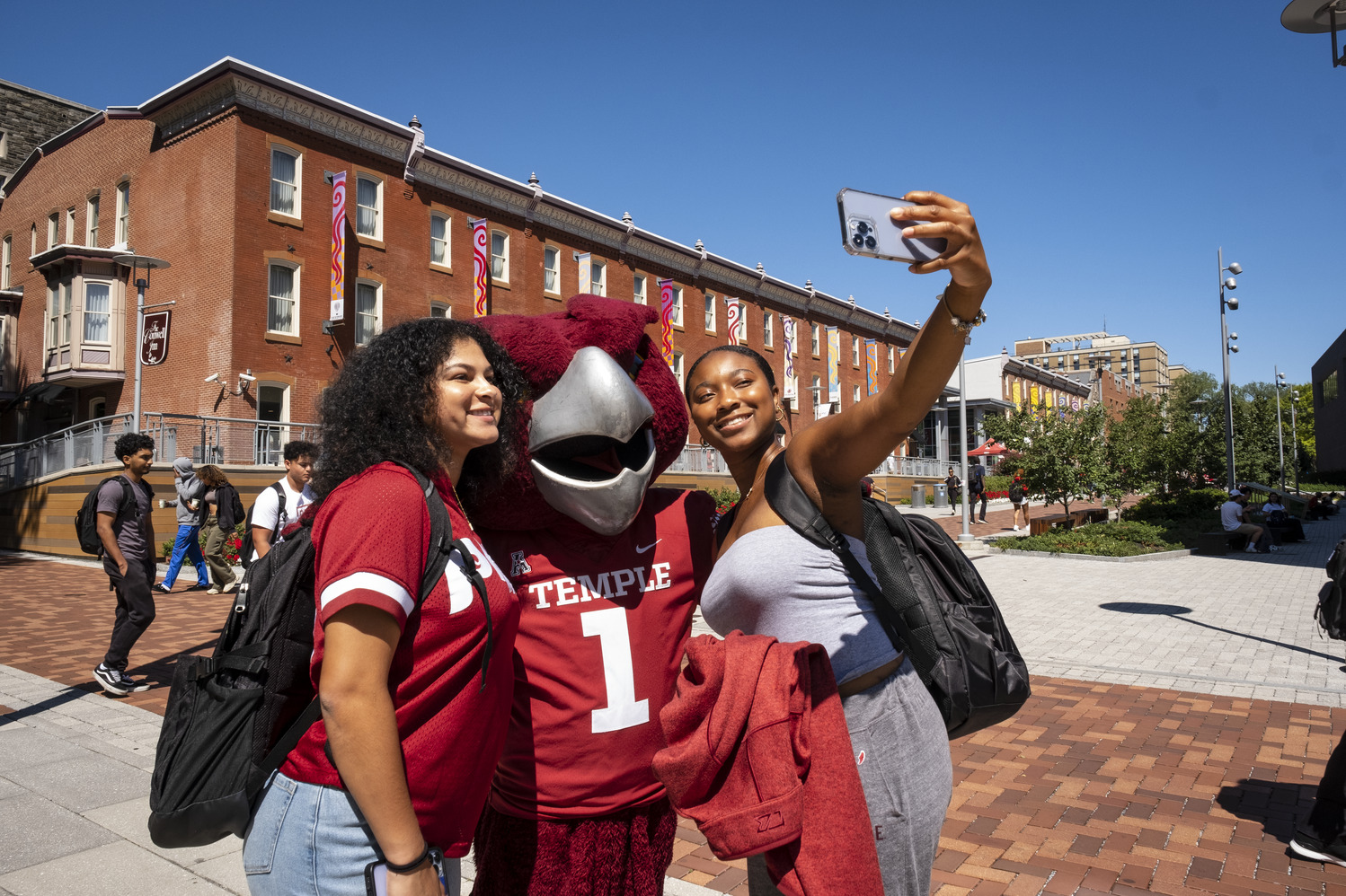 A photo of students taking a photo with Hooter.
