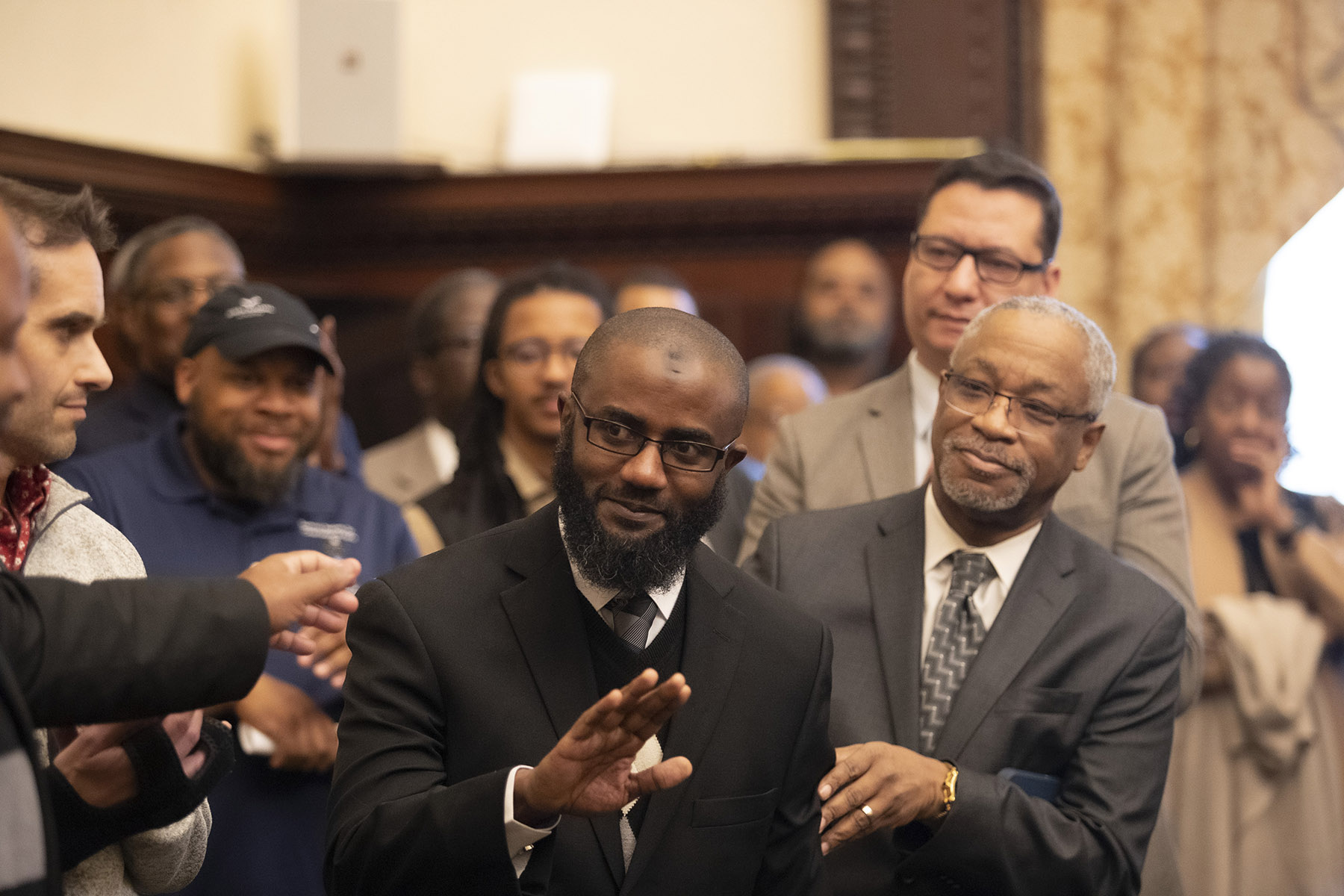 Temple faculty member Quaiser D. Abdullah interacts with Bishop Wilfred H. Speakes Sr. during a news conference held at City Hall. Abdullah will work closely with Speakes in his role as the city's director of Muslim engagement.