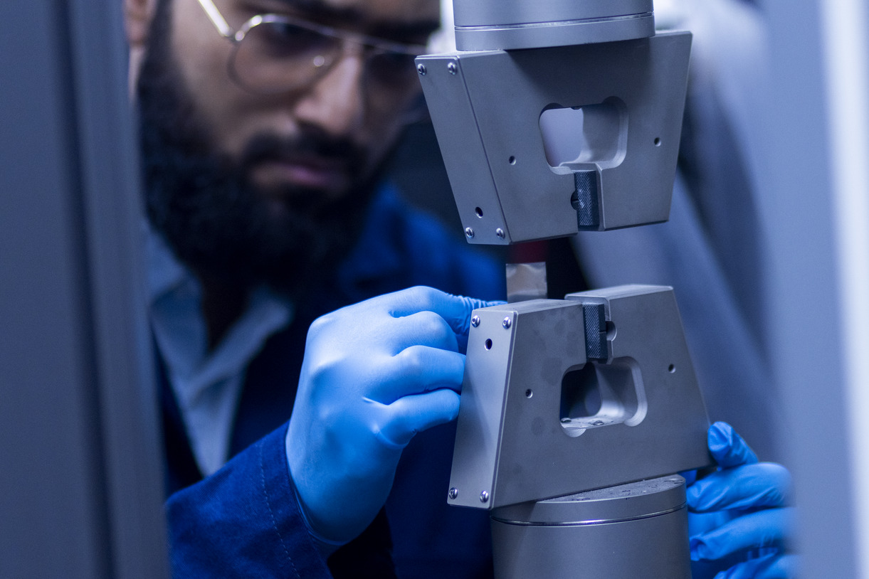 A graduate researcher working in the Electric Vehicle Safety Lab