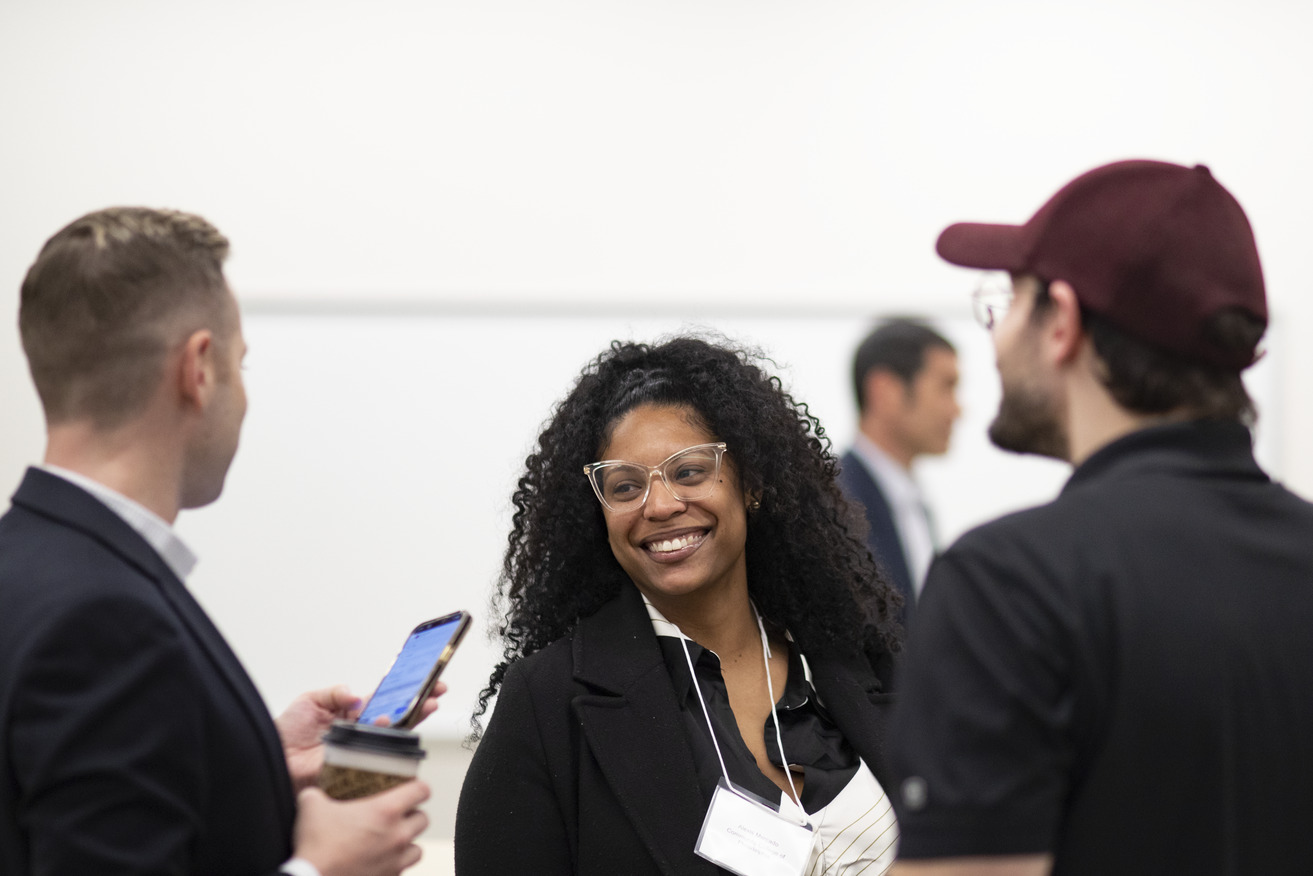 Image of people smiling inside the first-floor event space in Charles Library.