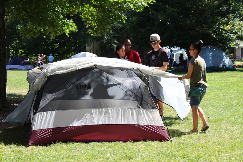 Campers putting up a tent