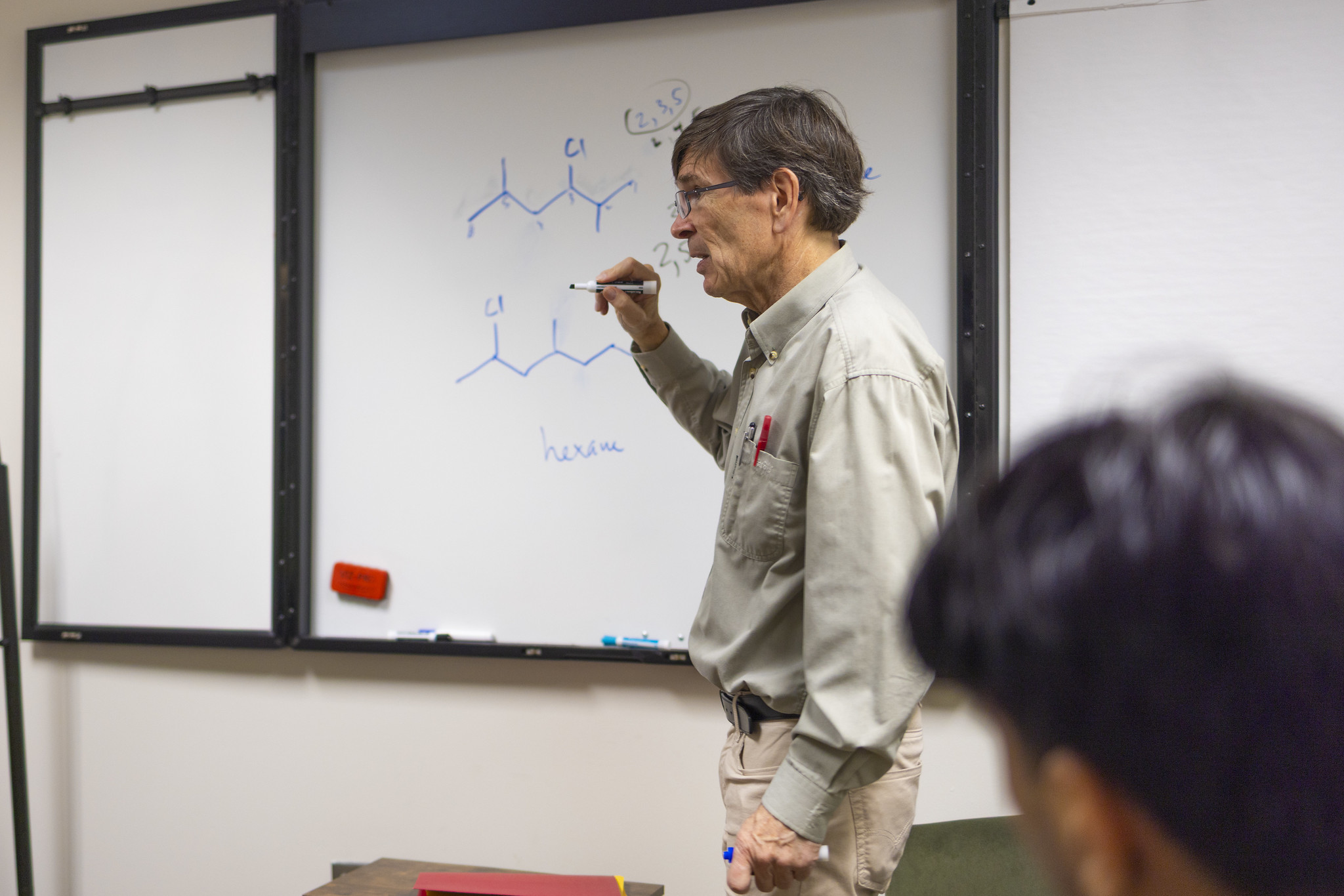 Prof. Fleming explaining a chemical drawn on a whiteboard