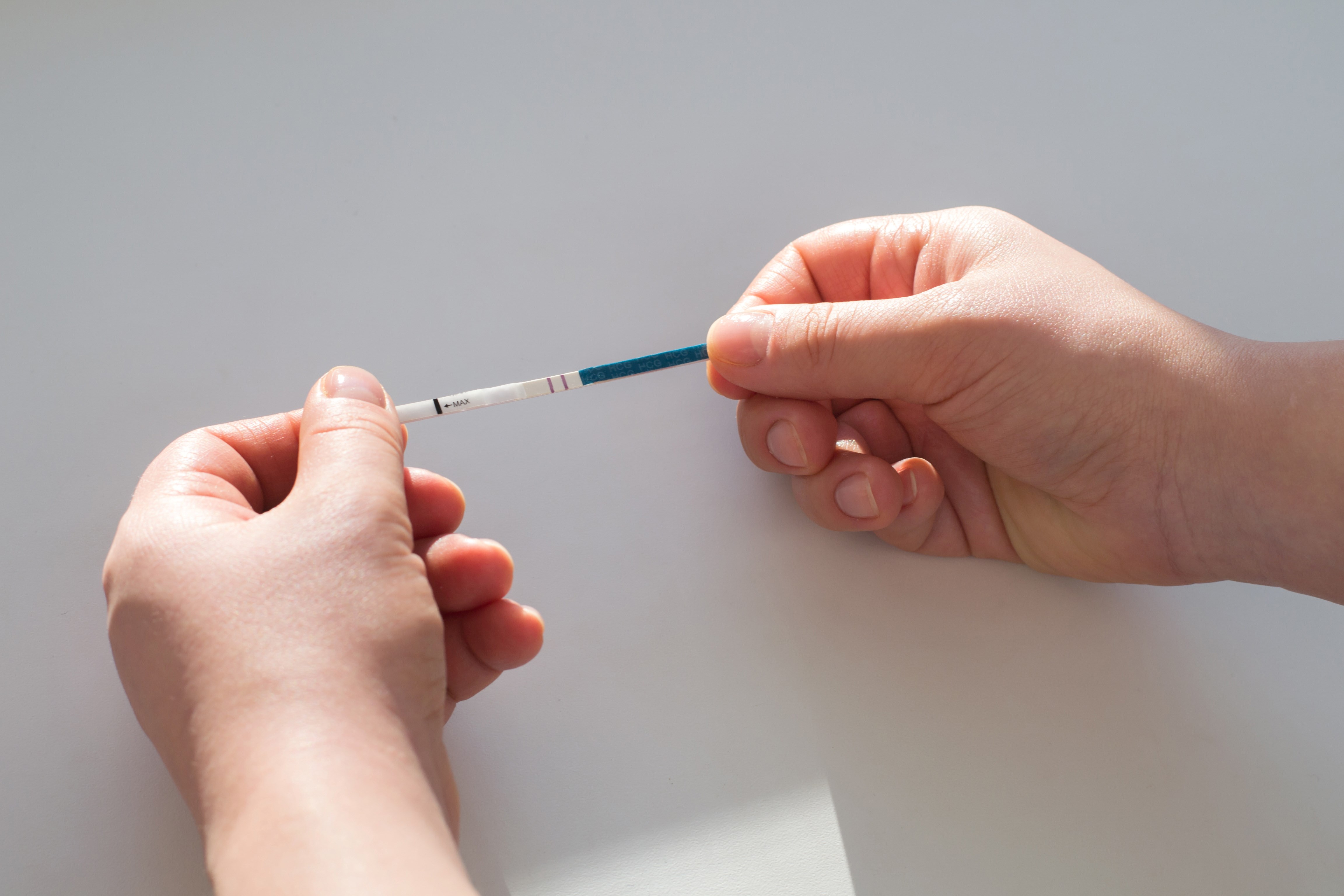 Hands holding a testing strip