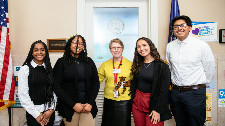 Eileen Dwell (center), wearing a yellow sweater.