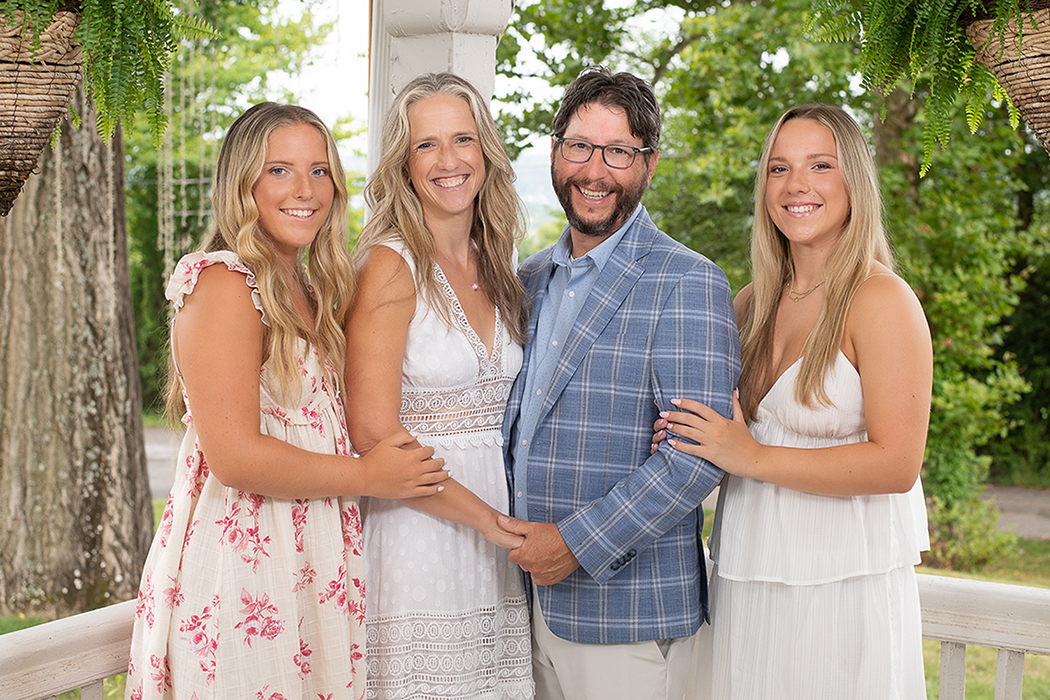 Bibelheimer family photo - young adult twin daughters on either side of Christine and Jerome