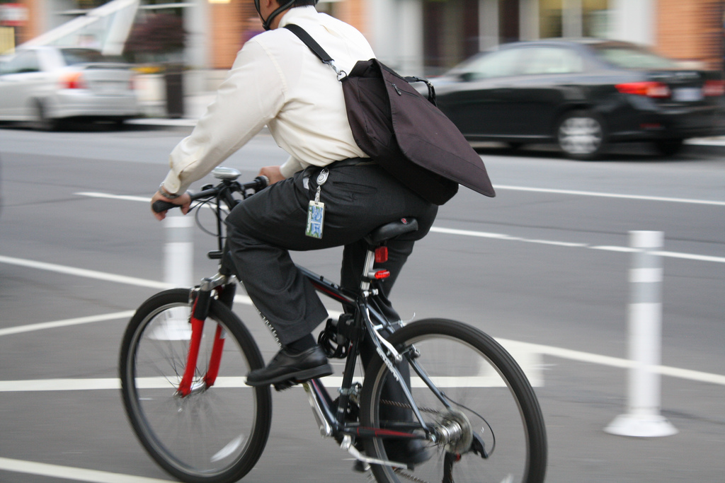 man on a bicycle in a protected lane for pedestrians and cyclists on a city street