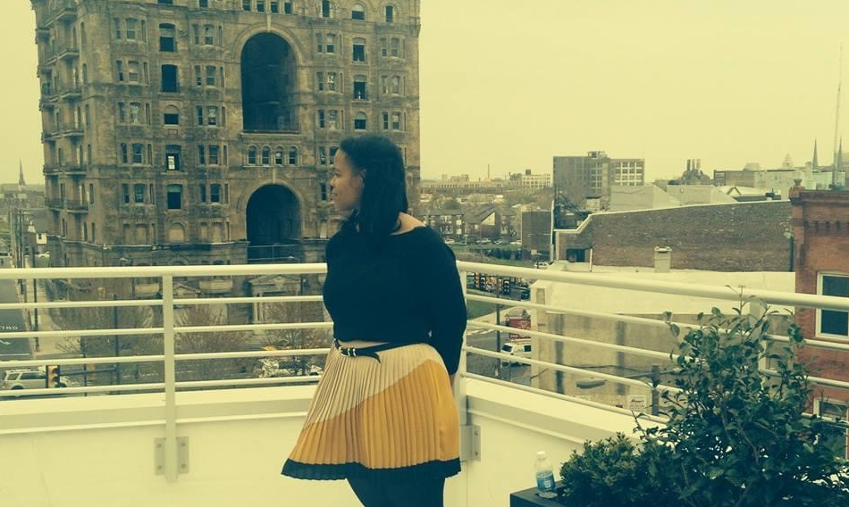 image of Cheryl standing on the rooftop of a building on Broad St in Philadelphia