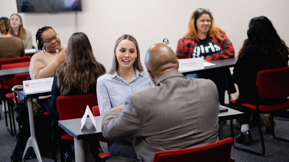 Public health undergraduate students participate in mock interviews with community partners at a career services event.