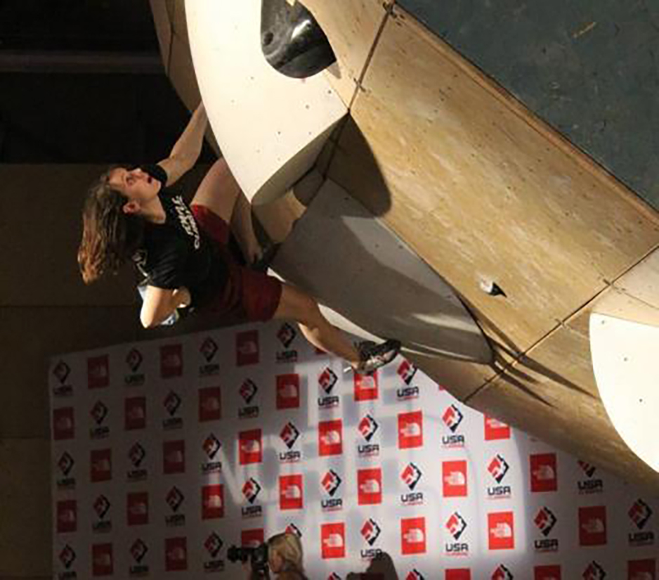 Student climbing rock climbing wall