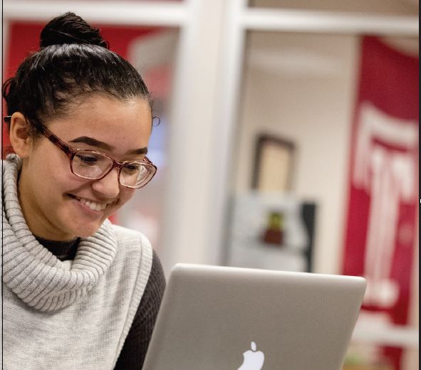 student attending virtual class on a laptop