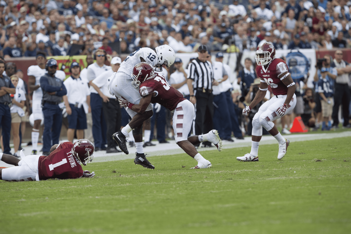 A Temple football player tackles a Penn State football player