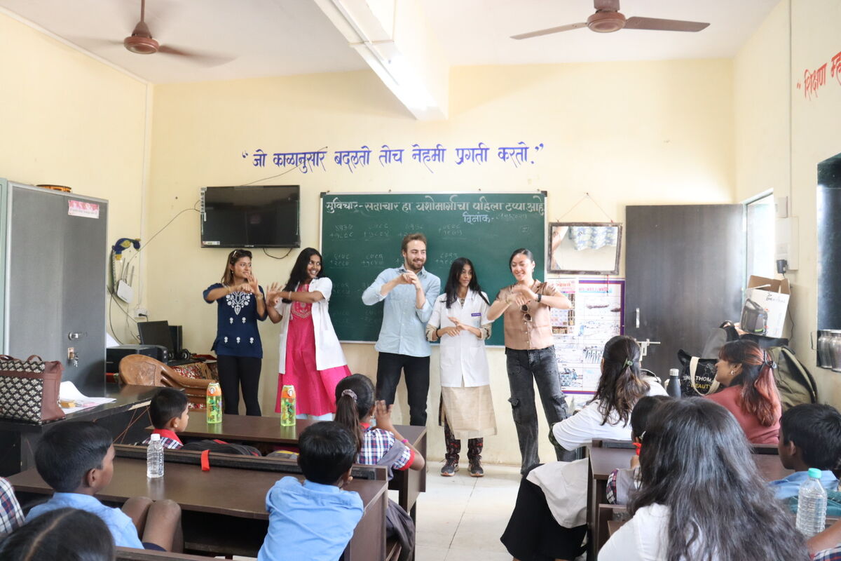 Temple and MGM students conducting an oral hygiene activity with children in a school in India