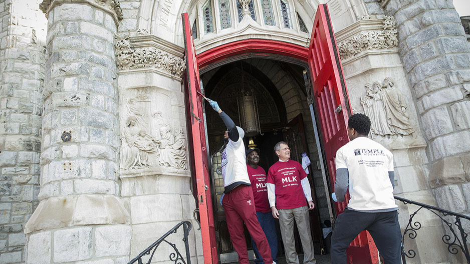 Volunteers working on the door of a church. 