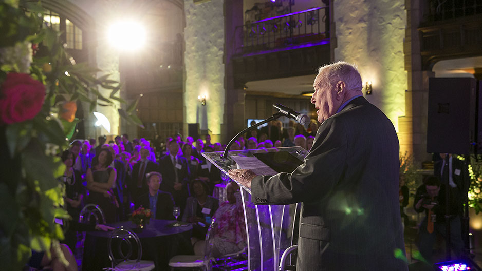 Lew Klein speaking at a podium. 