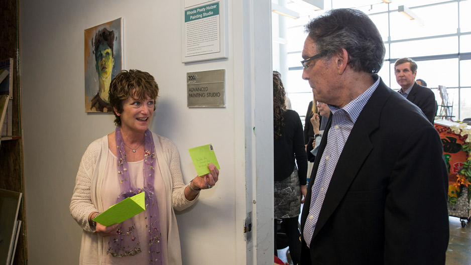 Debra Polen showing Stuart Holzer a letter.