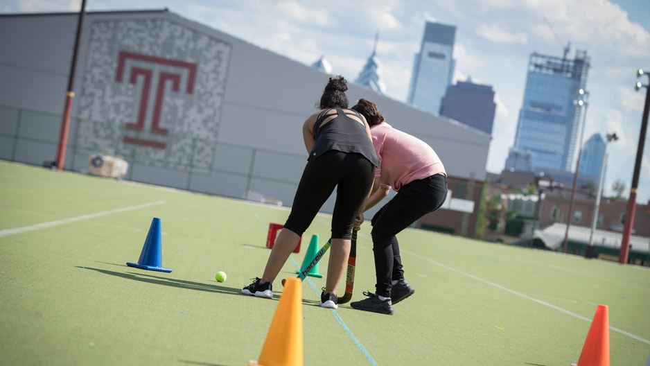 students playing field hockey