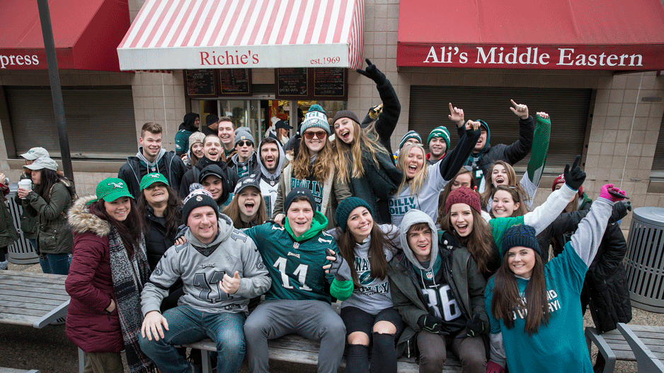 students in their Eagles gear outside the food wall on 12th Street