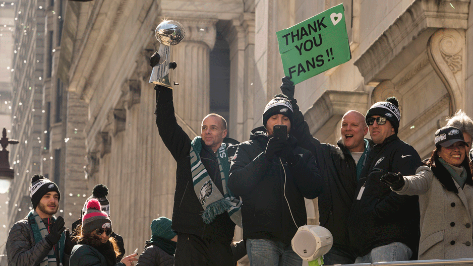 Eagles team members and managers on a bus during parade