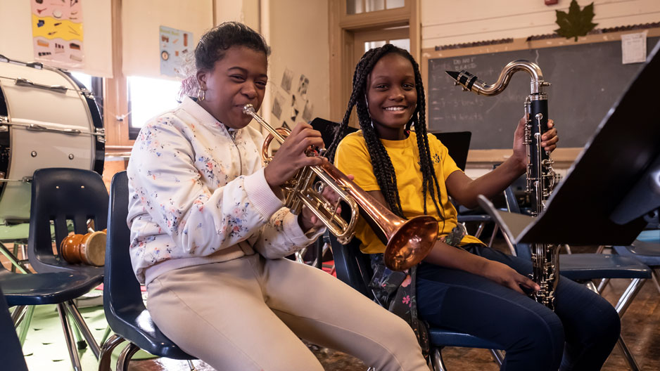 Sixth graders Heaven Skipworth and Zyikerra James playing instruments