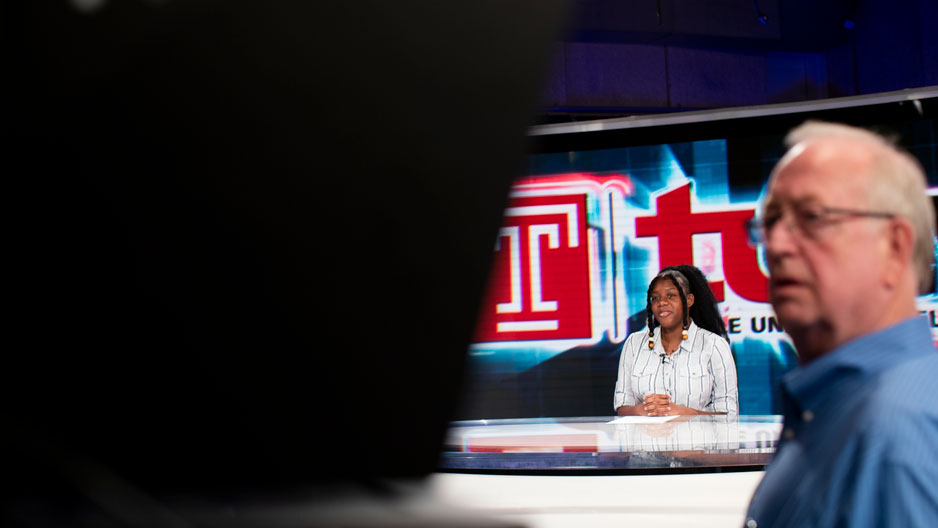 student at TUTV anchor desk