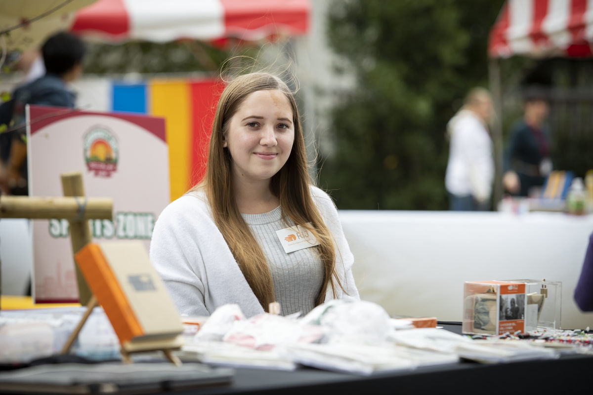 Student tables with an organization she is interning with at Community Day on TUJ's new campus. 