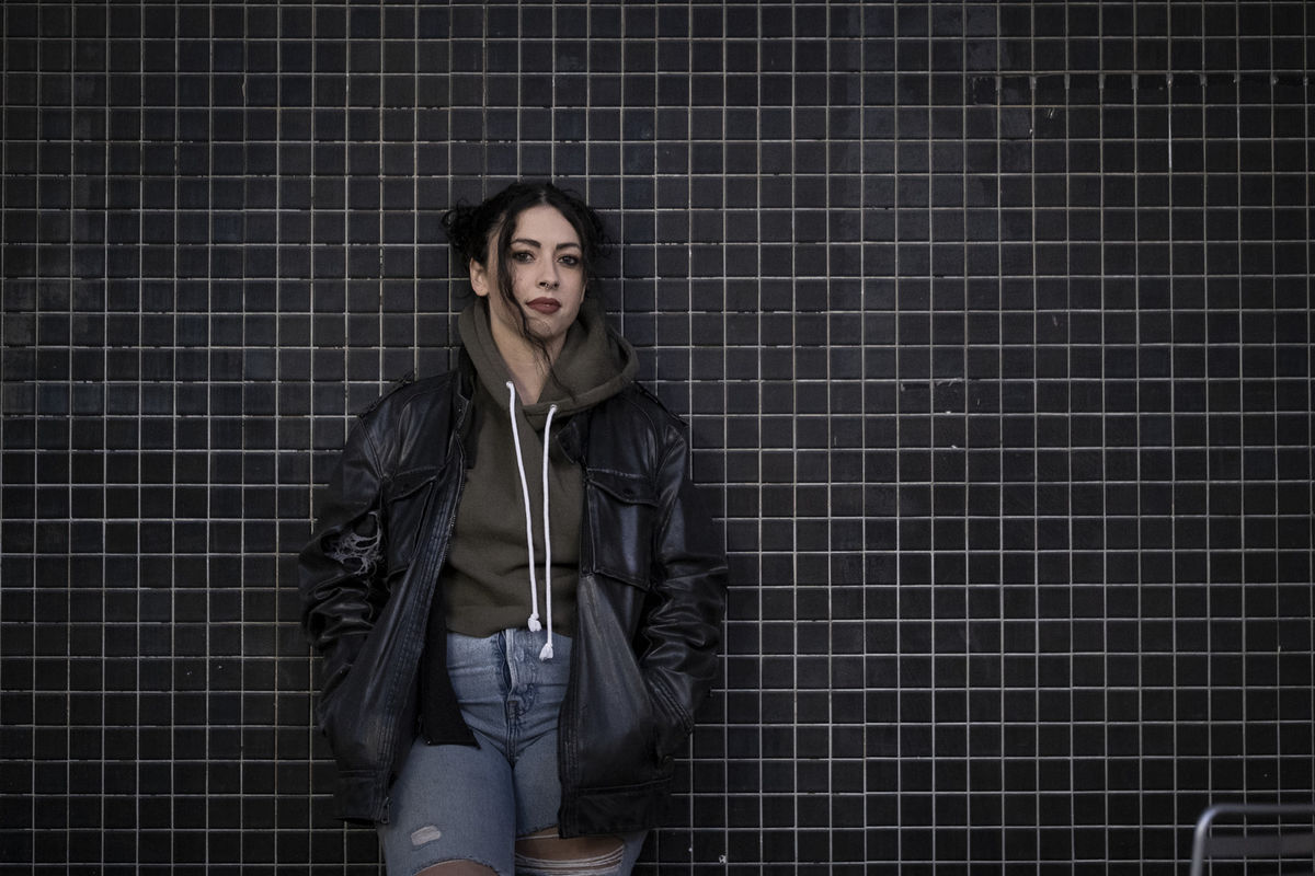 Jenna Faccenda standing in front of tiled wall on Temple’s Main Campus