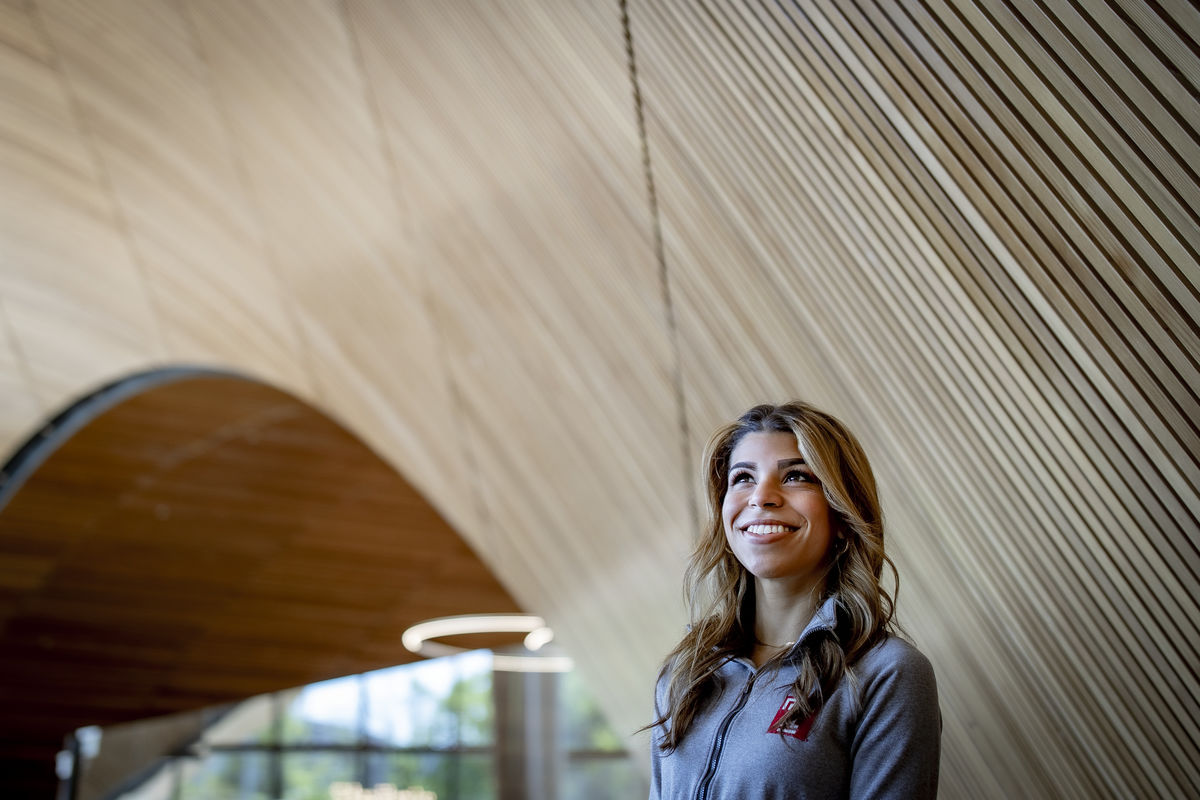 Sierra wearing a grey jacket with the Temple logo.