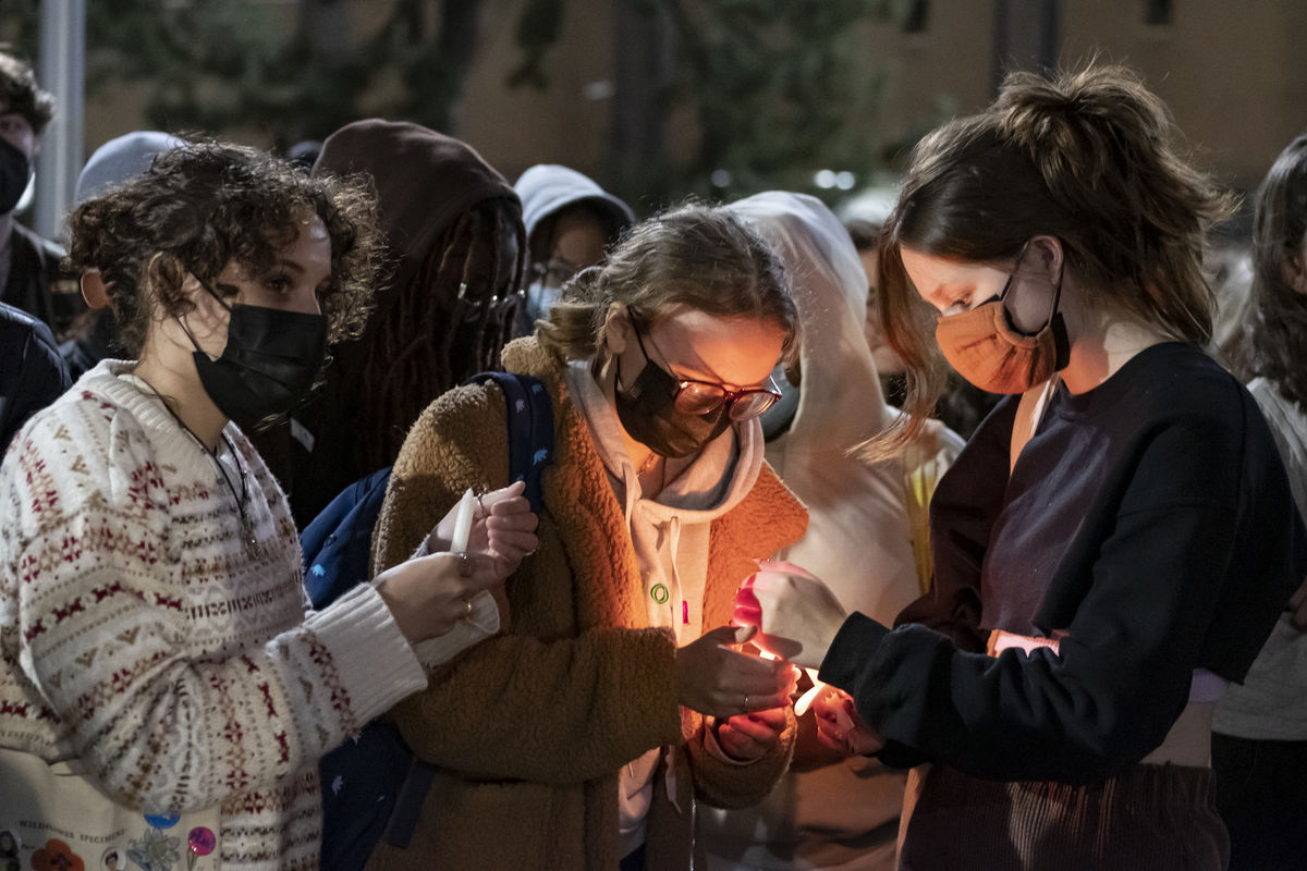 Students light candles during the candlelight vigil on Main Campus.