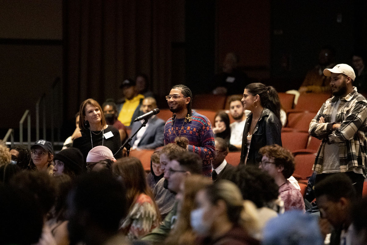 A student asking a question at the student conversation. 