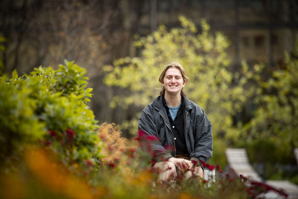 Mason Dofflemyer surrounded by greenery